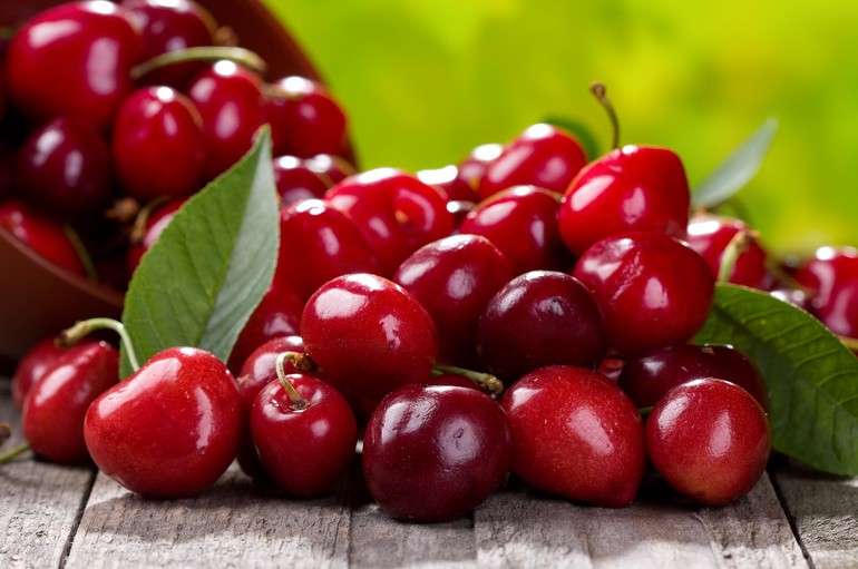 fresh cherries on wooden table